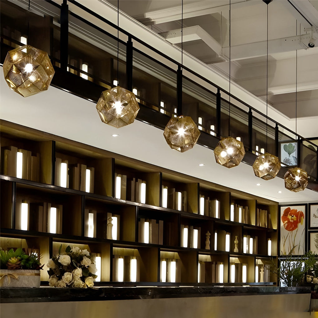 Metal shade pendant light arrangement above a bar area, casting warm patterned light across shelves and countertops.