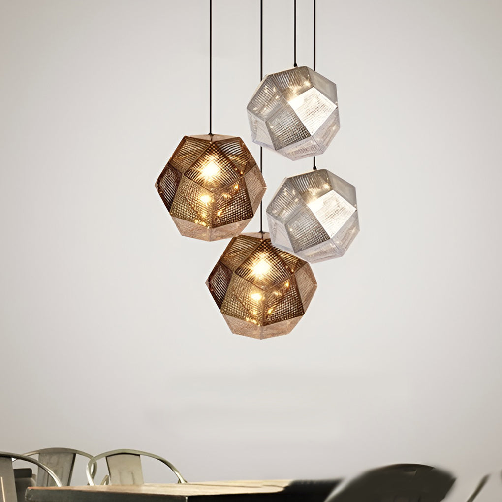 Clustered metal shade pendant light featuring faceted geometric forms, creating warm ambient lighting in a modern indoor space.