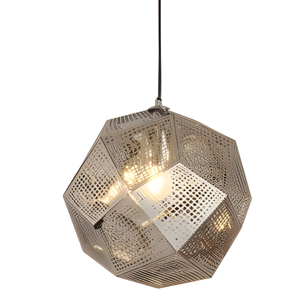 Silver-toned metal shade pendant light with geometric perforated panels, softly glowing in a minimal setting.