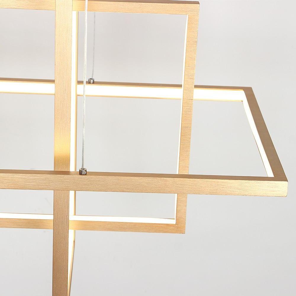 Minimalist dining room chandelier in gold finish showing close-up of brushed metal texture.