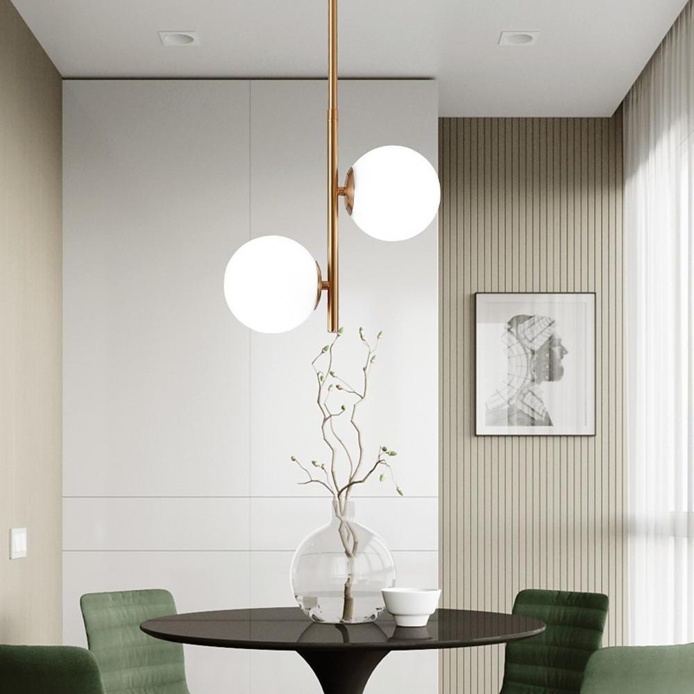 Modern Vertical Gold Pendant light over a minimalist round dining table with a beautiful vase!