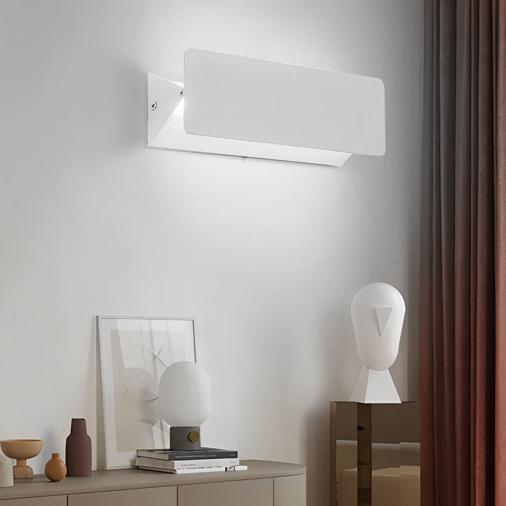 Minimalist wall adjustable light mounted above console table.