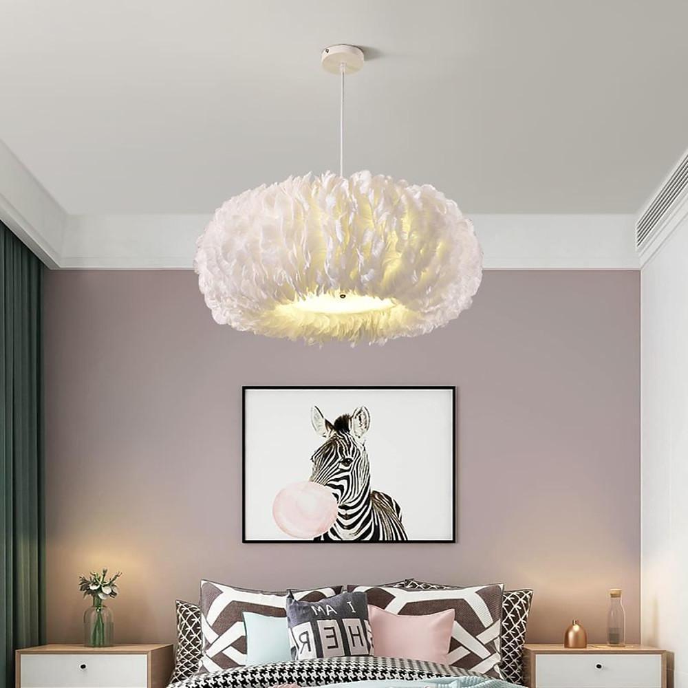 Modern bedroom interior decorated with a cloud like fluffy hanging light as a statement ceiling fixture.