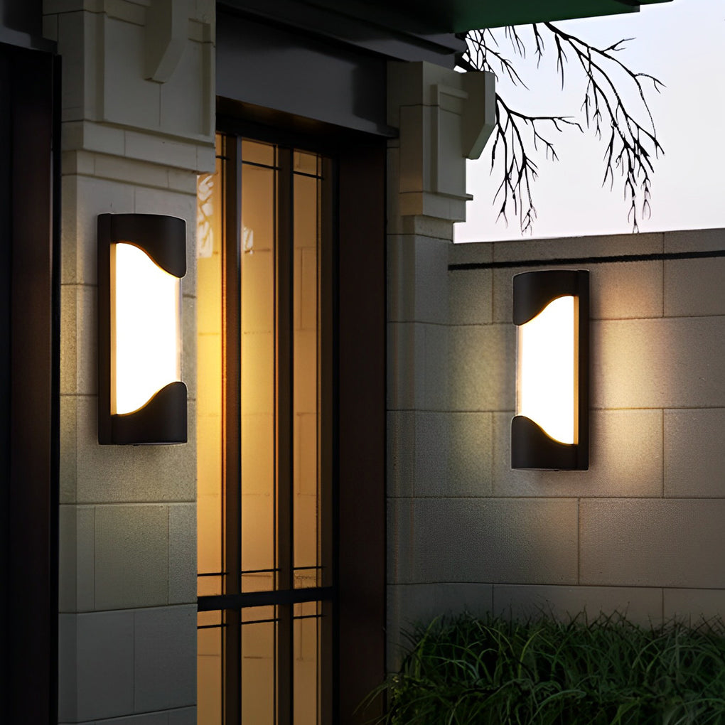 Black outdoor wall light with modern design on exterior wall near entrance.