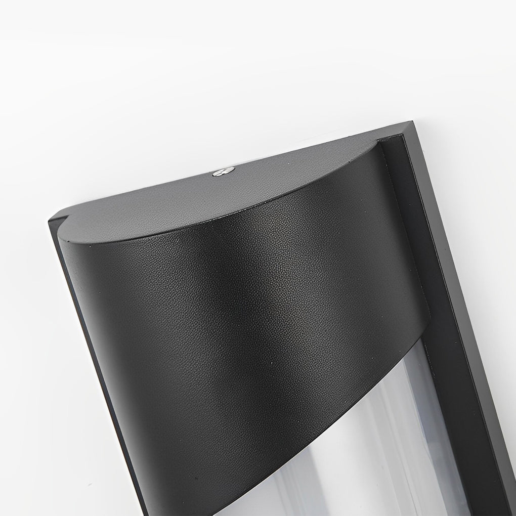 Black outdoor wall light with modern design on white wall near entrance door.
