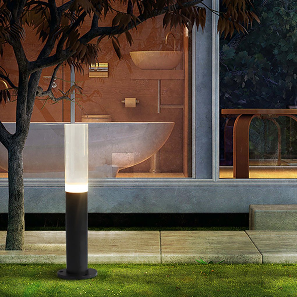 Modern bollard lighting enhancing a backyard with a warm glow and stepping stones.