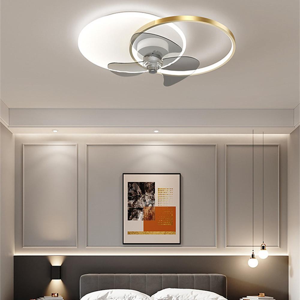Modern ceiling fan light with black and white finish above a headboard wall.