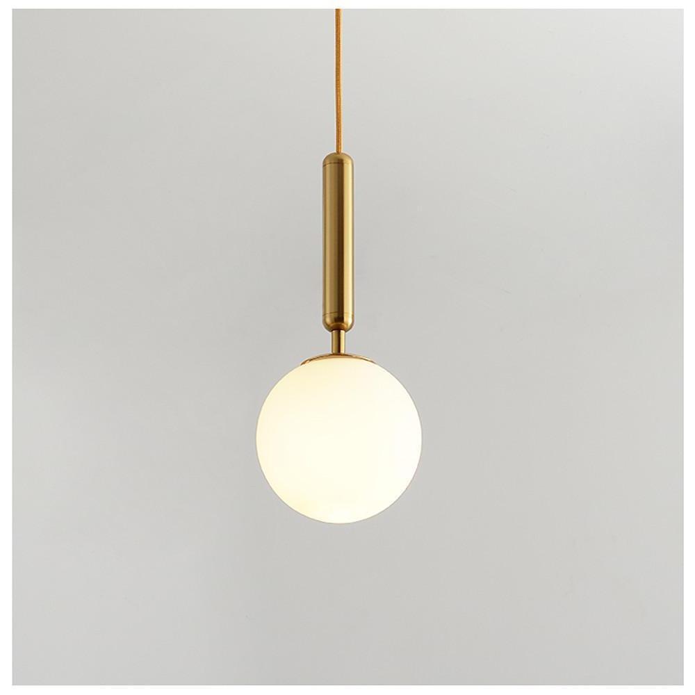 Modern frosted globe pendant light featuring a sleek brass pole and a white glass ball shade.