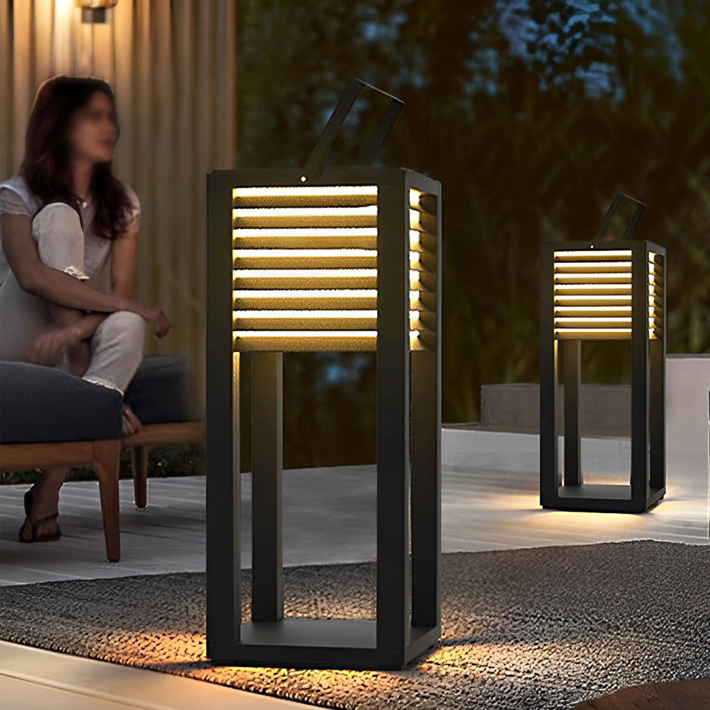 Modern outdoor floor lantern used as decorative lighting in a garden seating area.