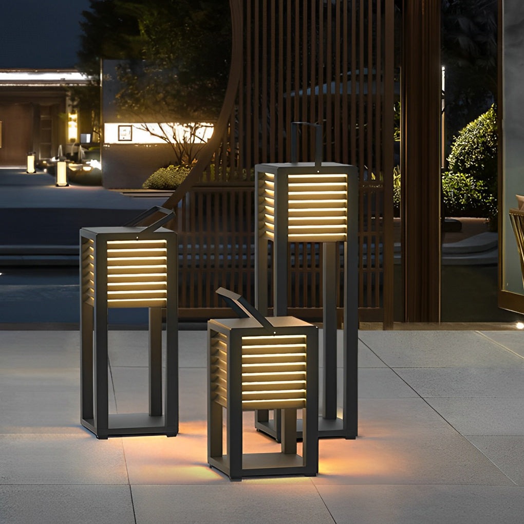 Modern outdoor floor lanterns arranged near outdoor steps and architectural elements.