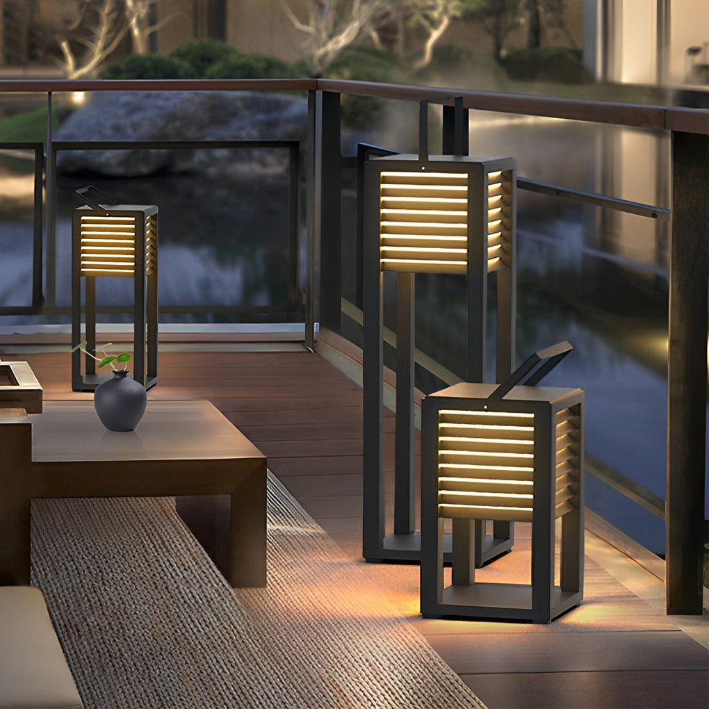 Modern outdoor floor lanterns placed along railing for terrace lighting design.