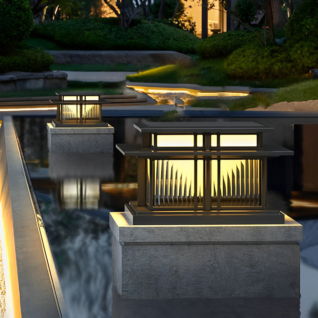 Modern porch pillar light installed beside a water feature, providing warm ambient outdoor illumination.