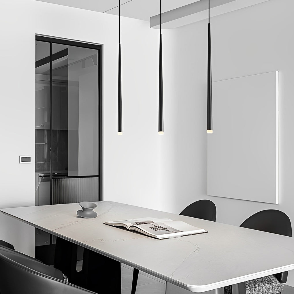 Modern Slim Black Pendant Light trio hanging over a white dining table in a minimal room.