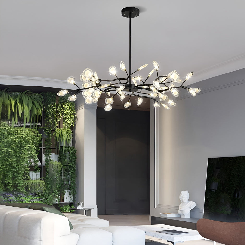 Modern tree branch chandelier in a living room with green wall accents.