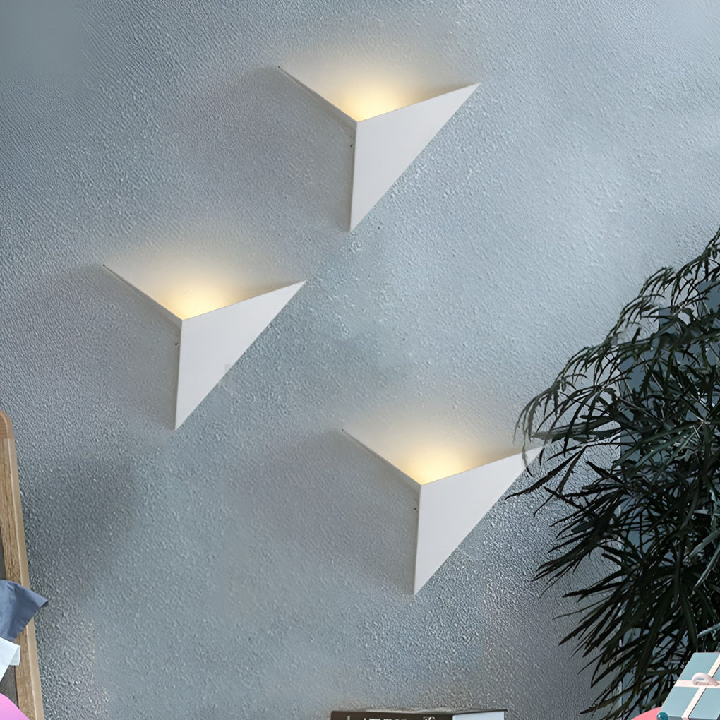 Modern triangle wall sconce with detailed view of its black and white finish.