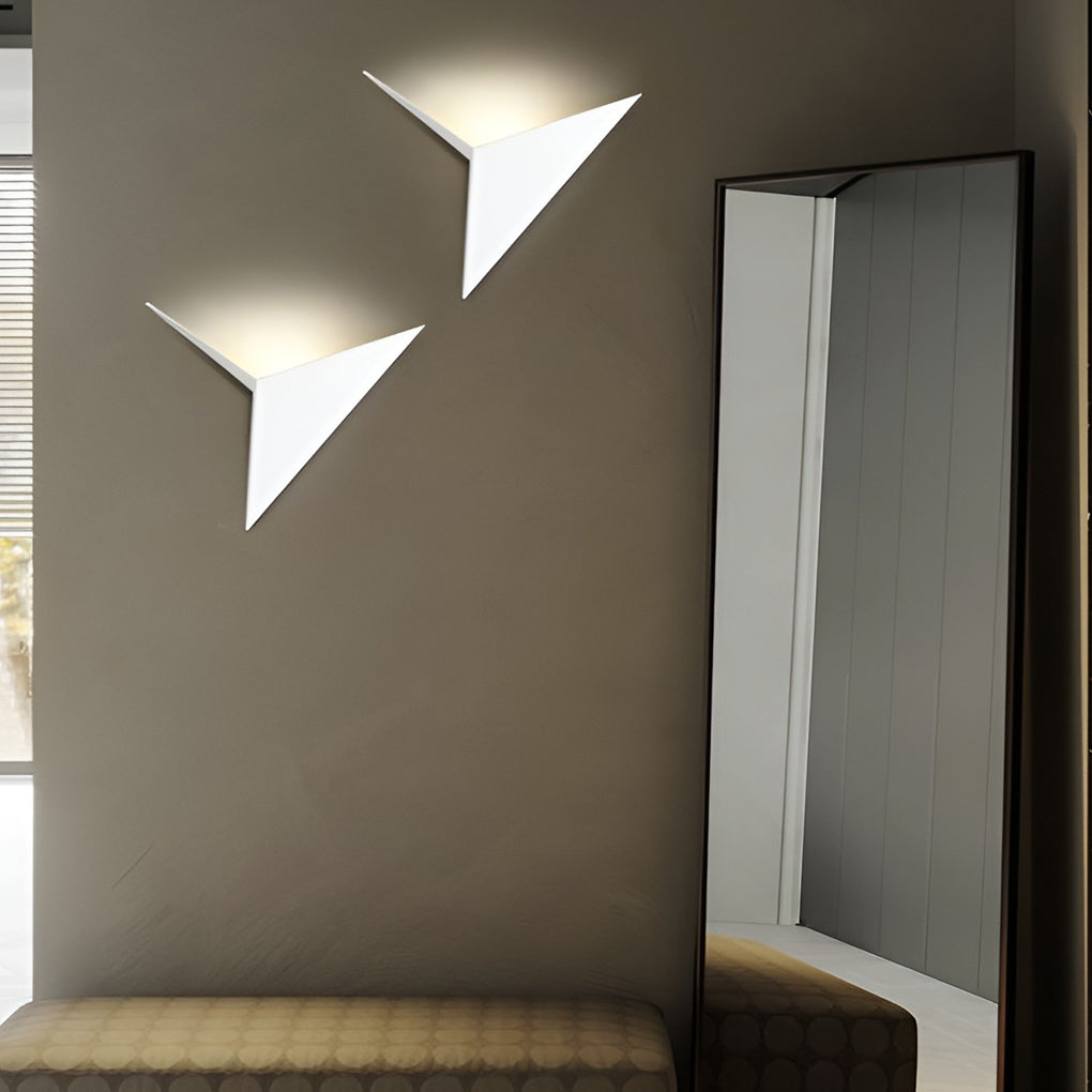 Modern triangle wall sconce providing elegant illumination for a contemporary study.