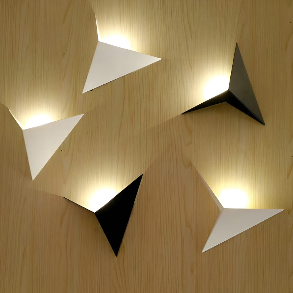 Modern triangle wall sconce with side view showing depth and structure.