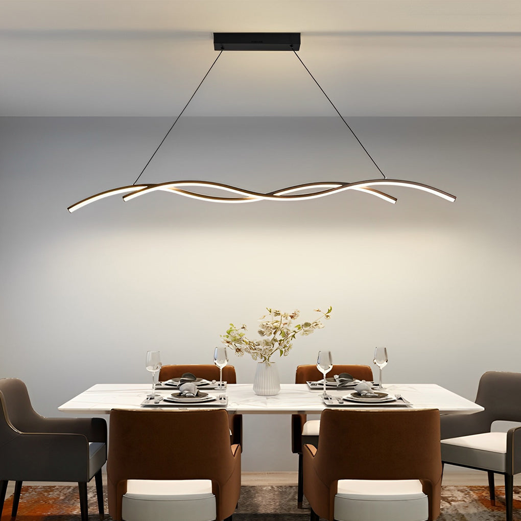 Modern wave LED pendant light with flowing linear design illuminating a contemporary dining space.