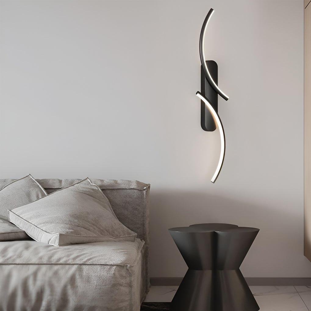 Modern wave wall sconce providing ambient light beside a cozy sofa.