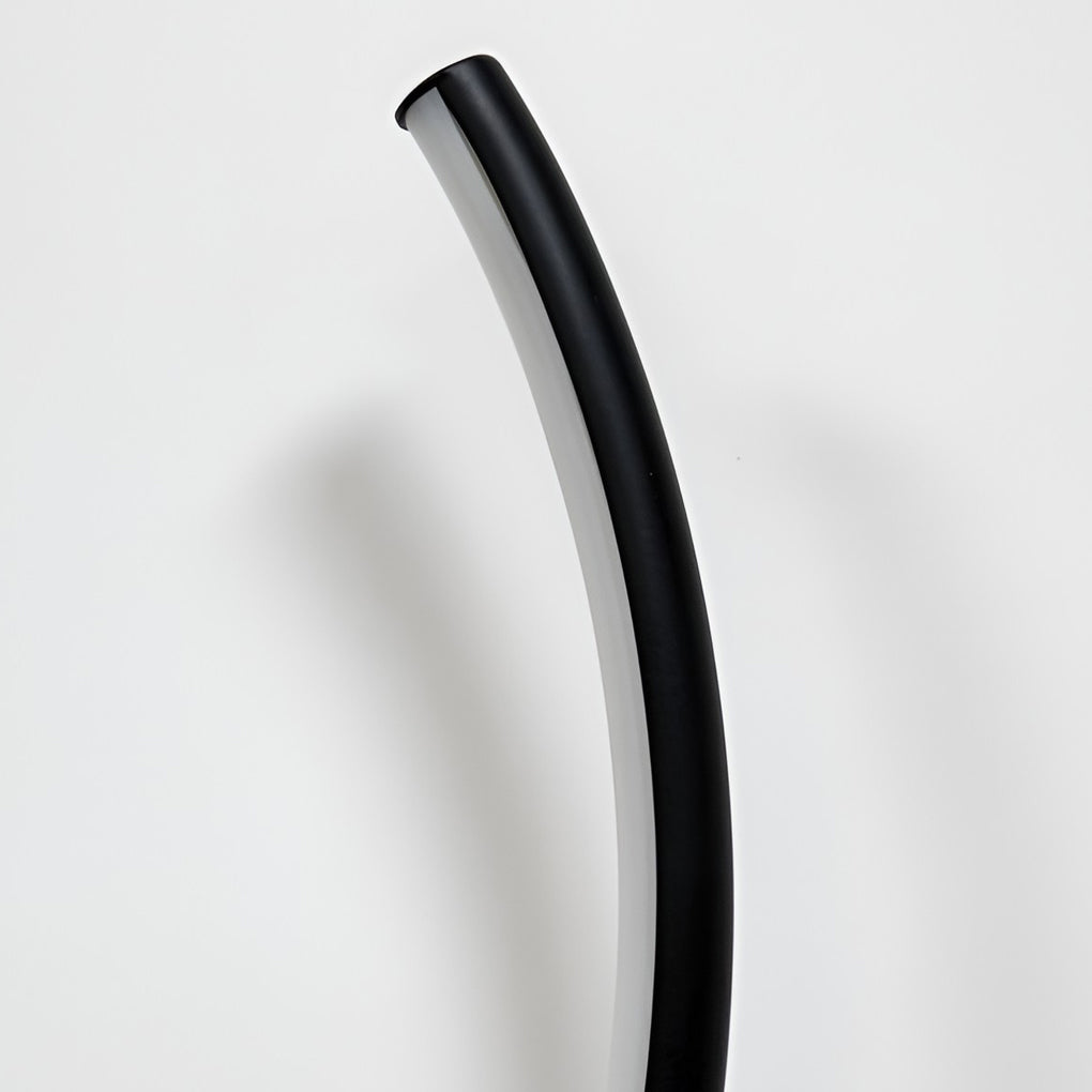 Modern wave wall sconce with a close-up of the curved light fixture.