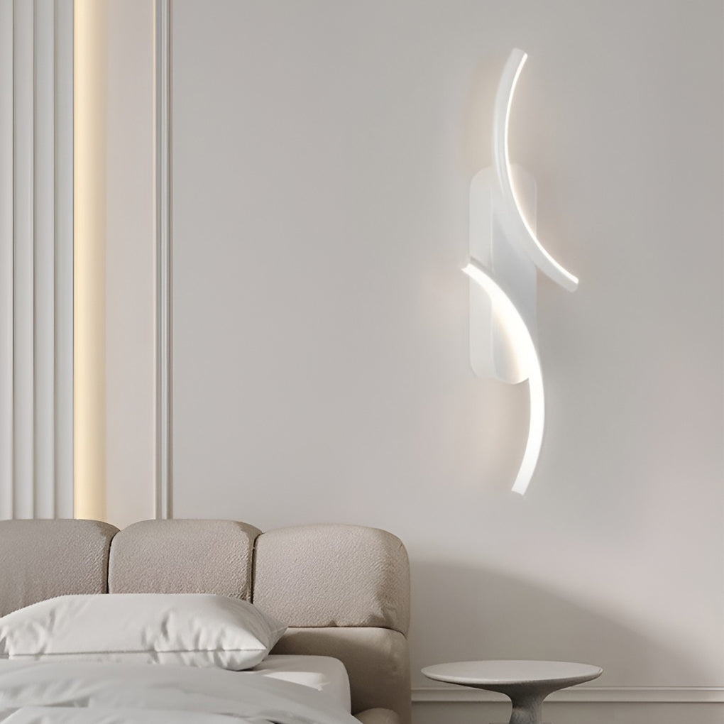 Modern wave wall sconce casting a gentle glow in a stylish indoor setting.