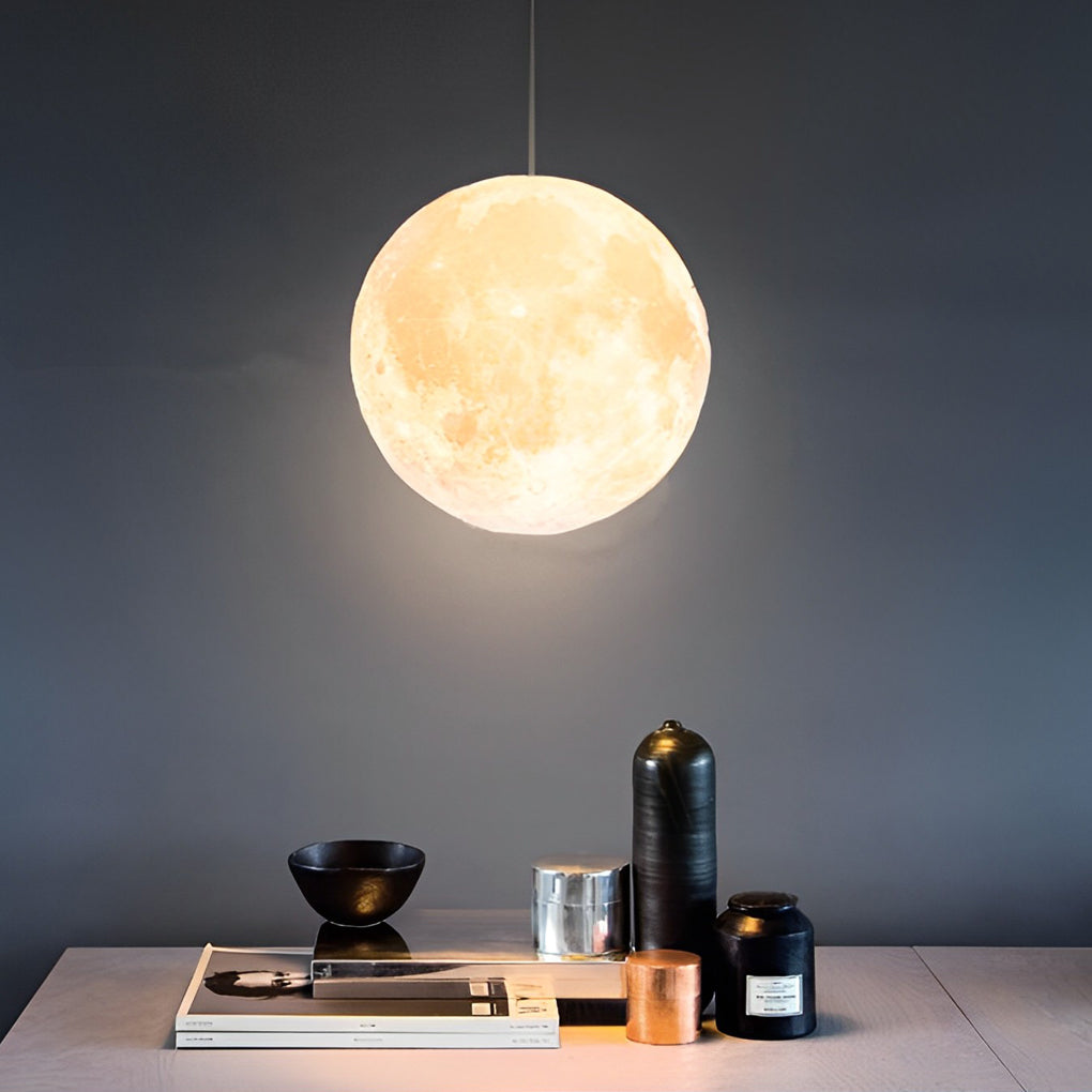 Moon globe pendant light hanging beside bed as bedside lighting.