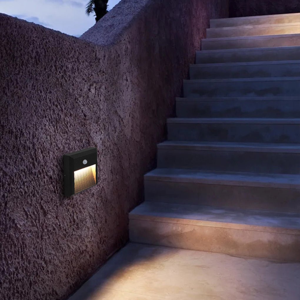 Motion sensor LED step lights providing subtle light on a stone pathway.