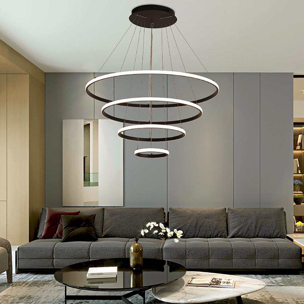 Multi-ring LED chandelier suspended in modern living room interior.