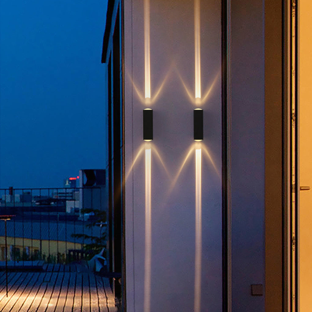 Vertical narrow beam wall sconce casting sharp light patterns on a building facade, highlighting architectural lines at night.