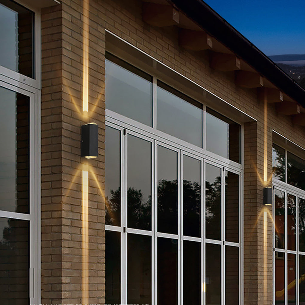 Narrow beam wall sconce mounted on a modern building with large windows, emphasizing vertical light accents along the facade.