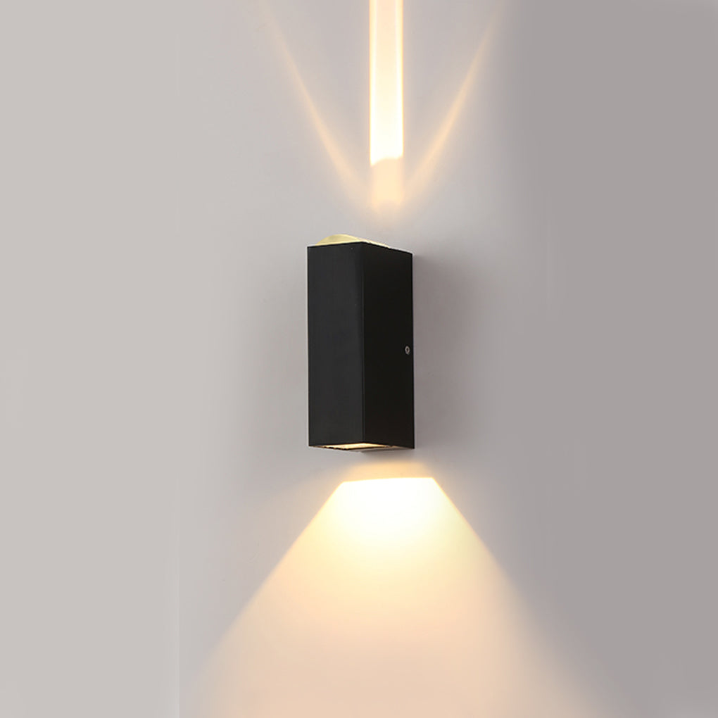 Narrow beam wall sconce emitting a warm downward glow, ideal for subtle exterior accent lighting applications.