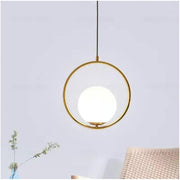 Chic minimalist hanging lamp featuring an opal glass ball in a bright and airy living space.
