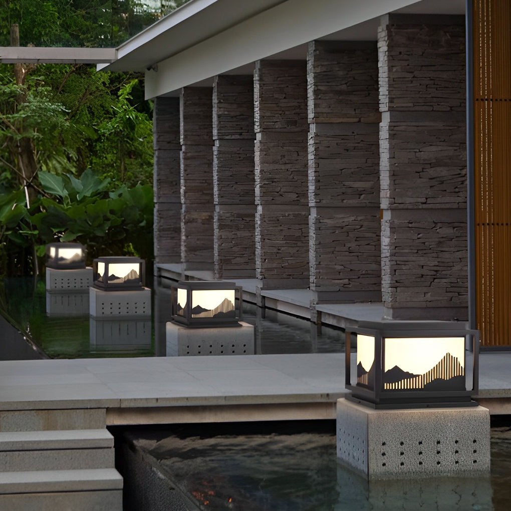 Outdoor brick pillar lights illuminating a cozy outdoor deck with directional glow.