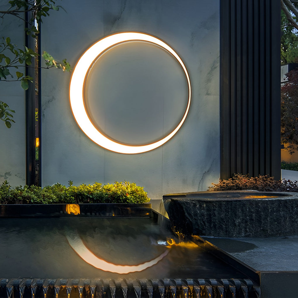 Outdoor cylinder wall light reflected over a water basin, highlighting clean lines and modern exterior wall lighting design.