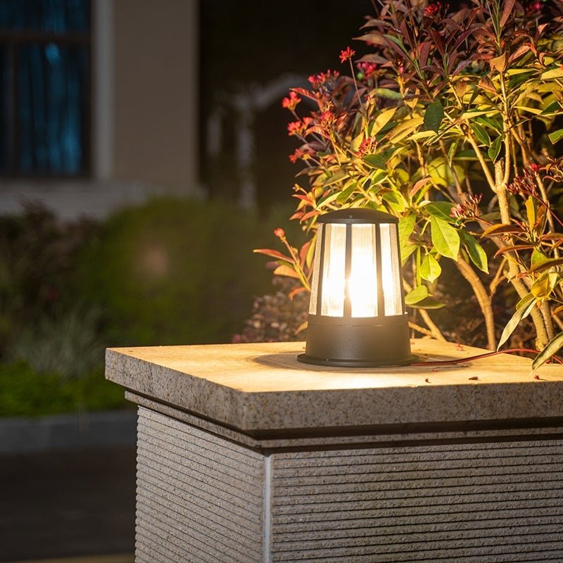 Outdoor garden path lamp illuminating a serene garden path surrounded by greenery.