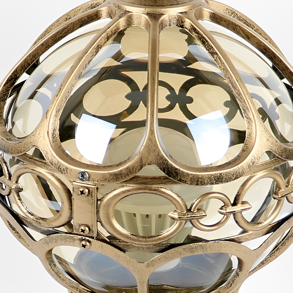 Top view of outdoor globe pillar lights, highlighting the ornate gold finial and lattice sphere design.