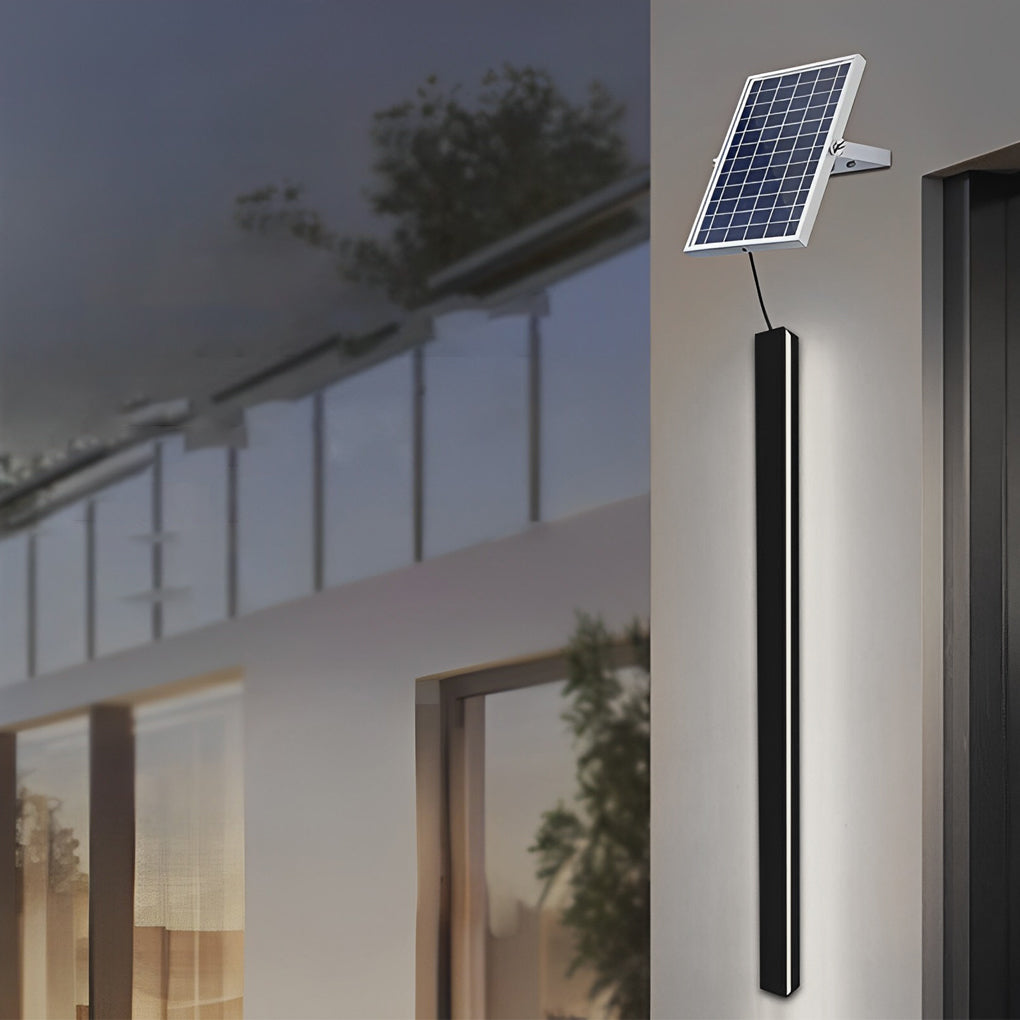 Outdoor linear wall light with solar panel mounted on exterior wall for energy-efficient lighting.