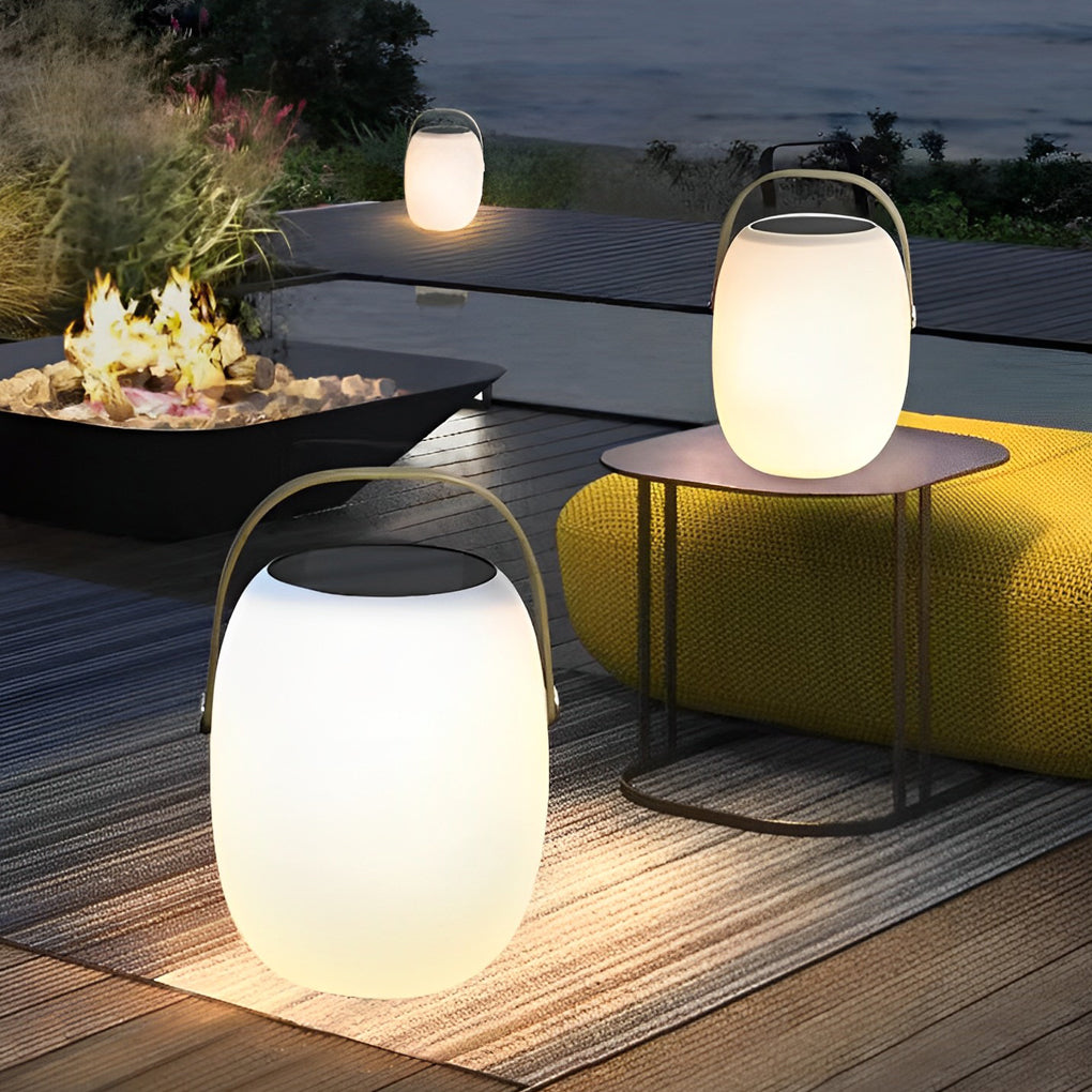 Outdoor solar floor lanterns illuminating garden patio with warm glow at night.