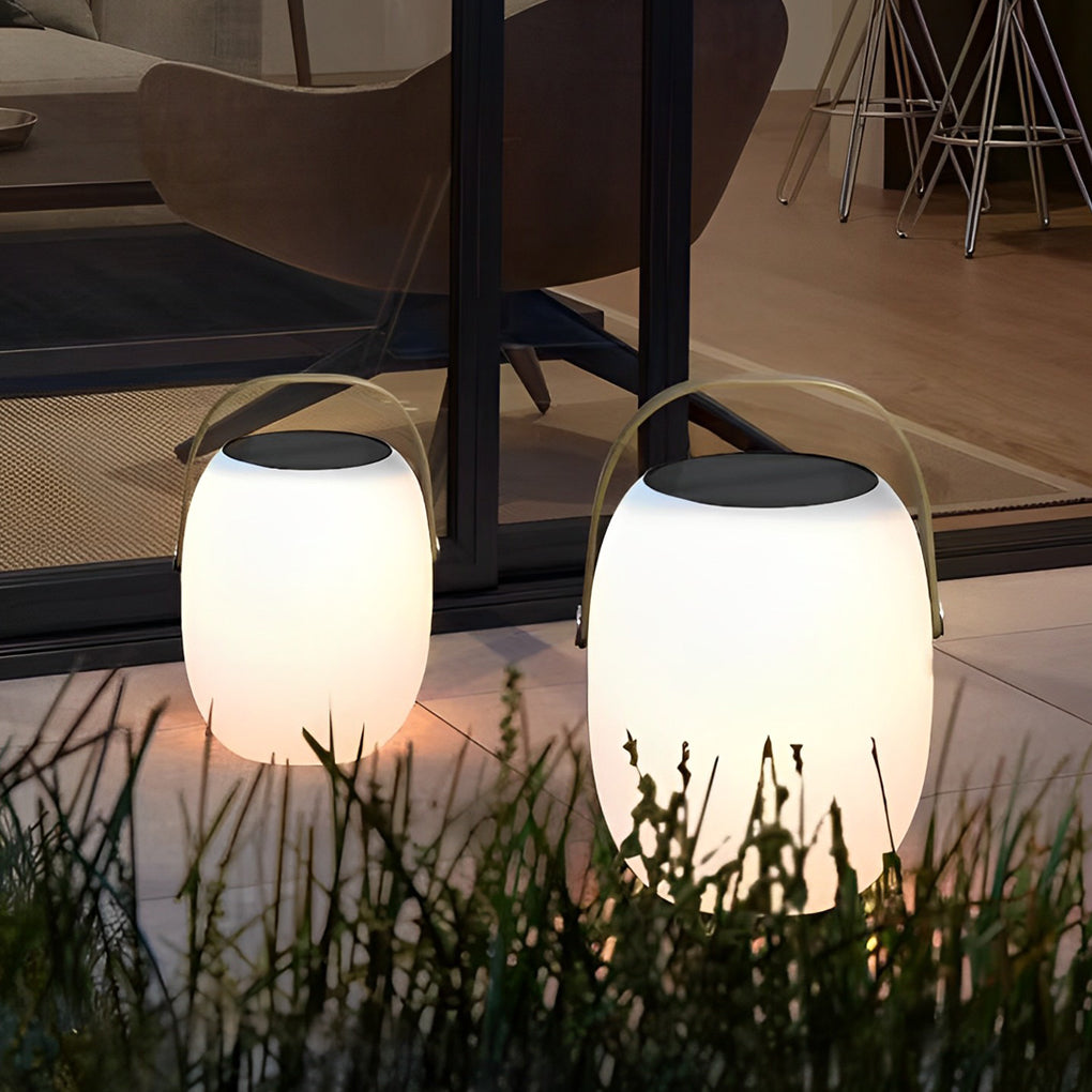 Outdoor solar floor lanterns casting ambient light on outdoor dining table.