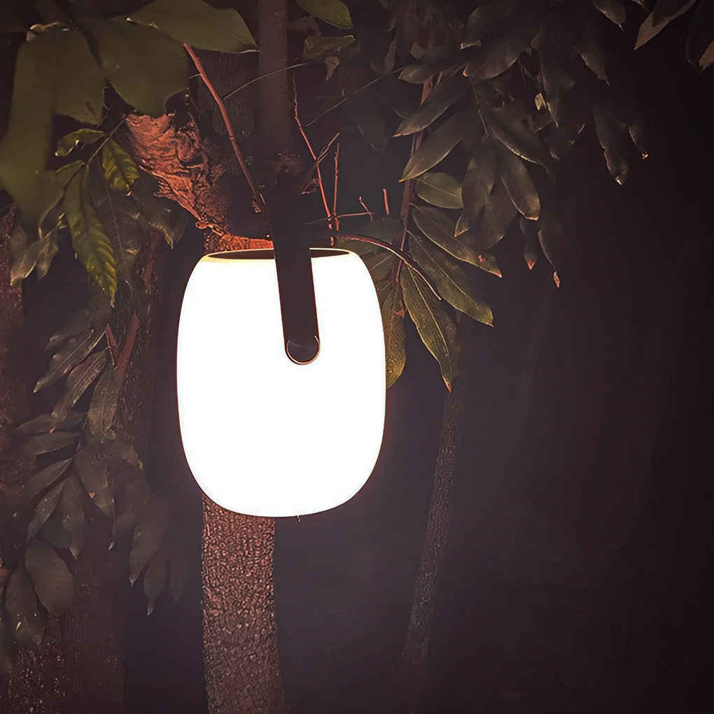 Outdoor solar floor lanterns beside poolside lounge area at dusk.