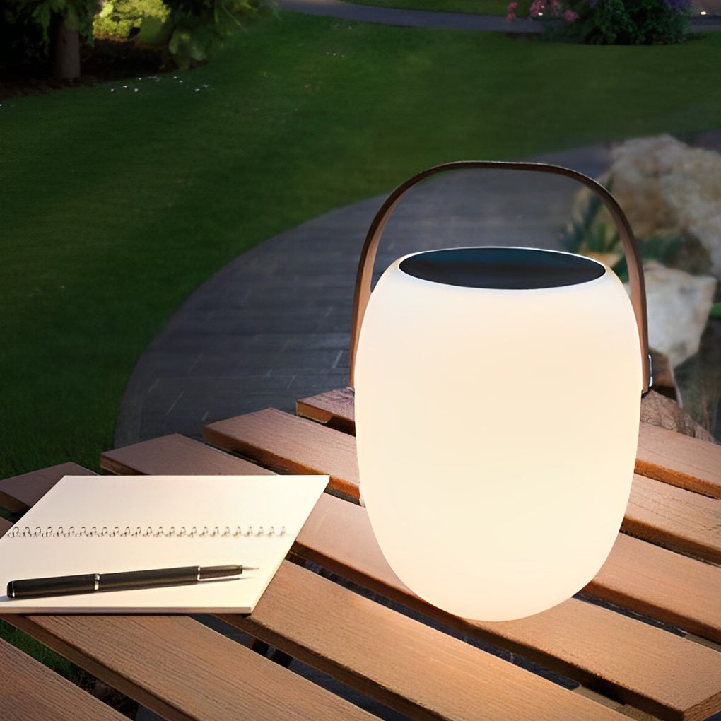 Outdoor solar floor lanterns placed on wooden table with soft lighting.