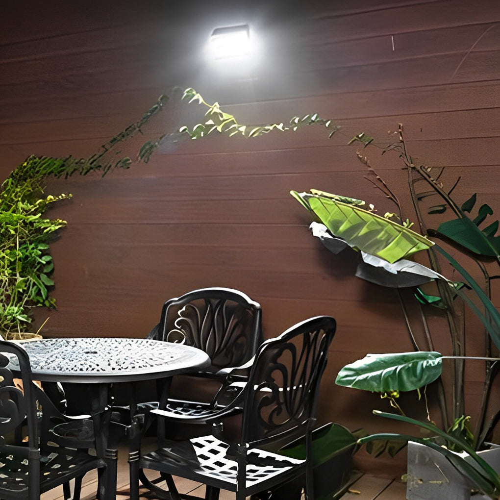 Outdoor solar wall light with motion sensor enhancing a garden pathway with directional lighting.
