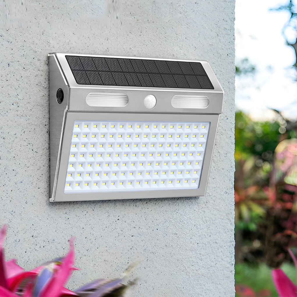 Outdoor solar wall light with motion sensor casting a gentle glow near a fence.