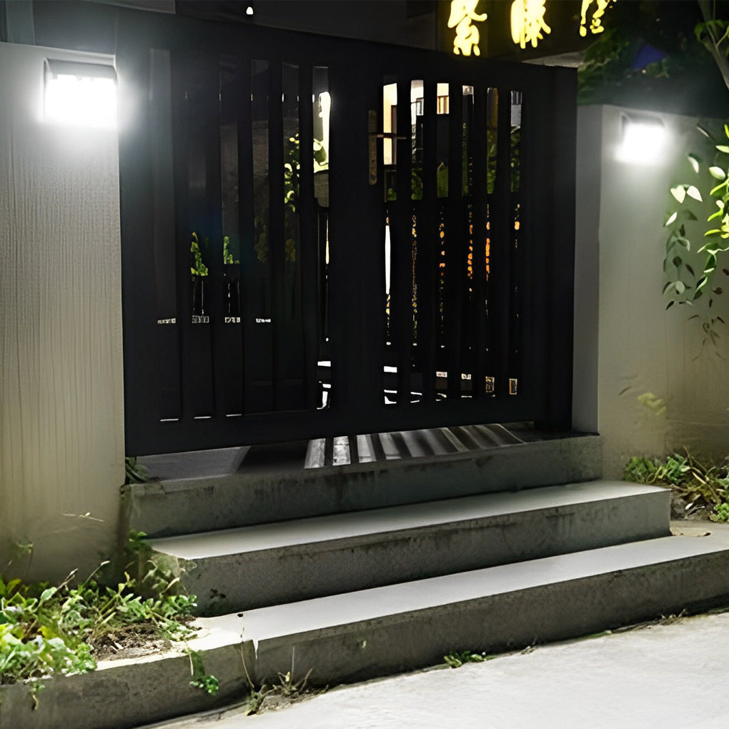 Outdoor solar wall light with motion sensor illuminating a modern driveway with ambient light.
