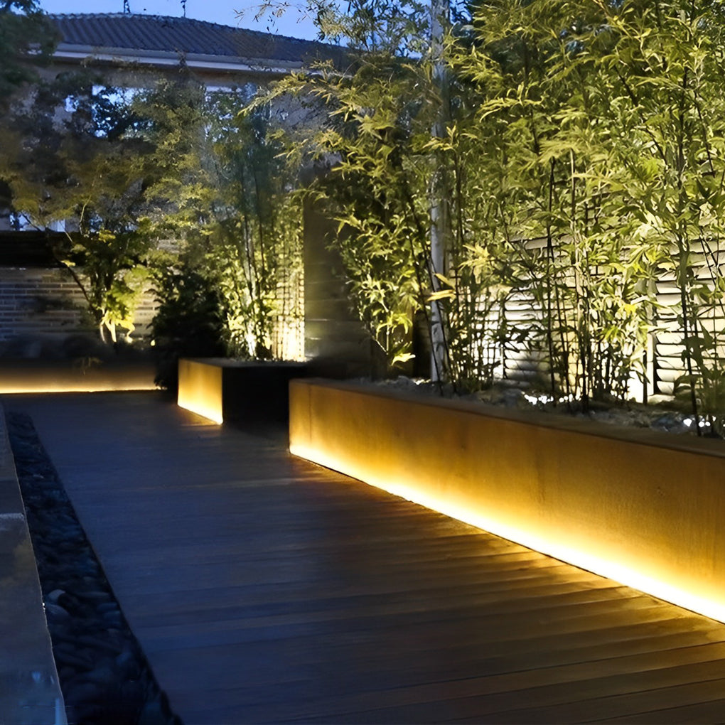 Outdoor stair lighting strips casting a gentle glow along a modern outdoor walkway.