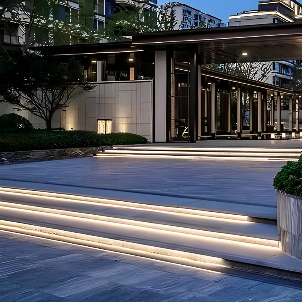Outdoor stair lighting strips enhancing a modern patio with subtle, continuous illumination.