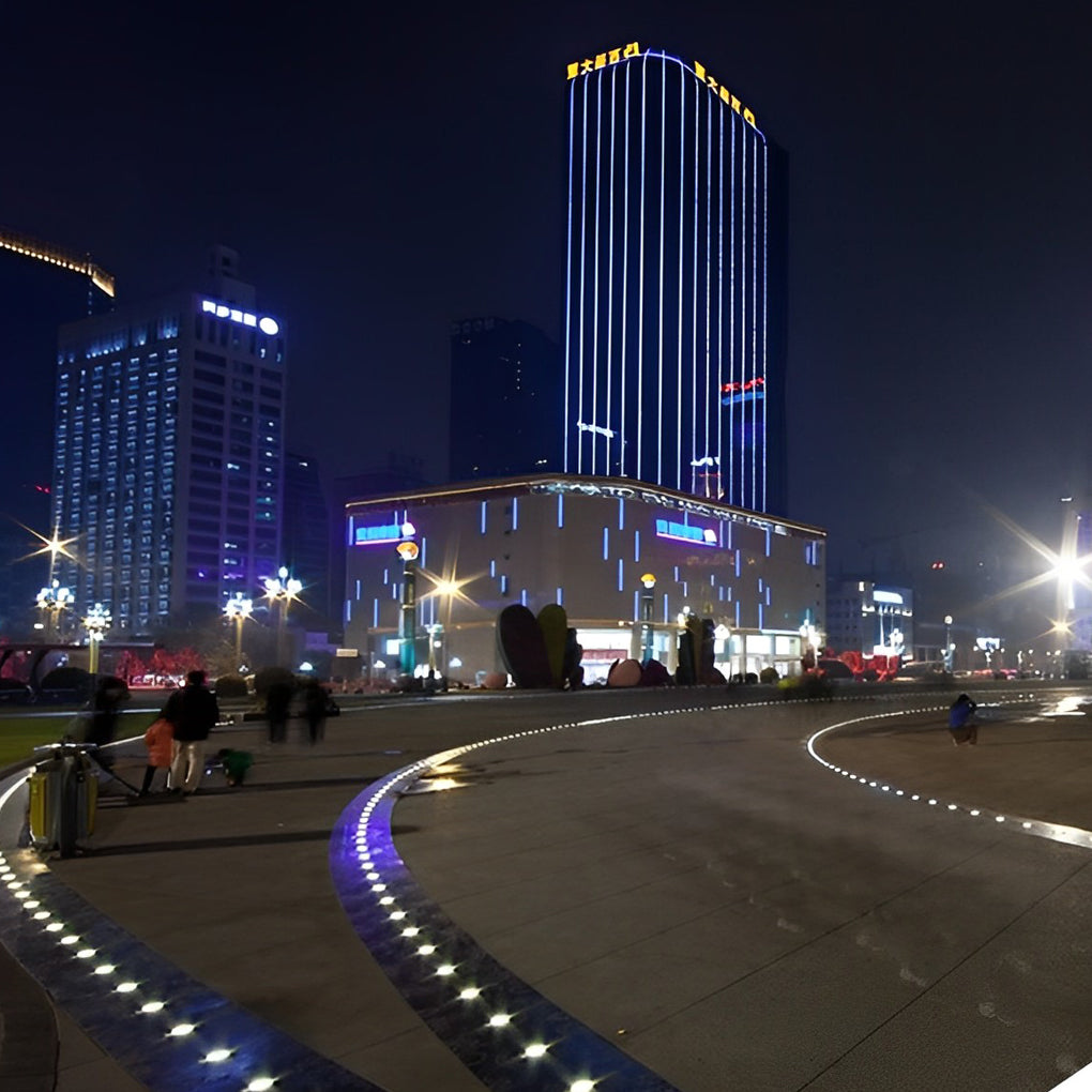 Outdoor step light fixtures illuminating a bridge walkway with blue and white lights.
