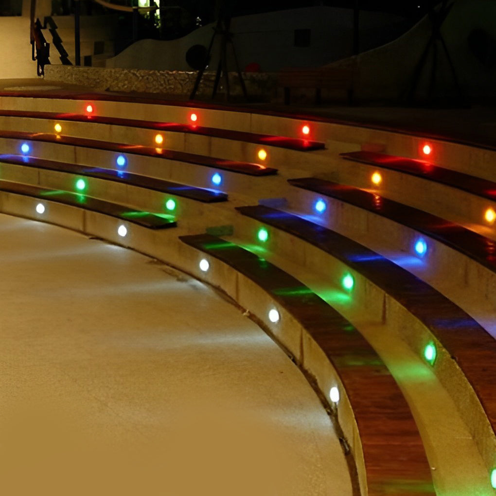 Outdoor step light fixtures lighting up a city sidewalk, creating a modern urban ambiance.