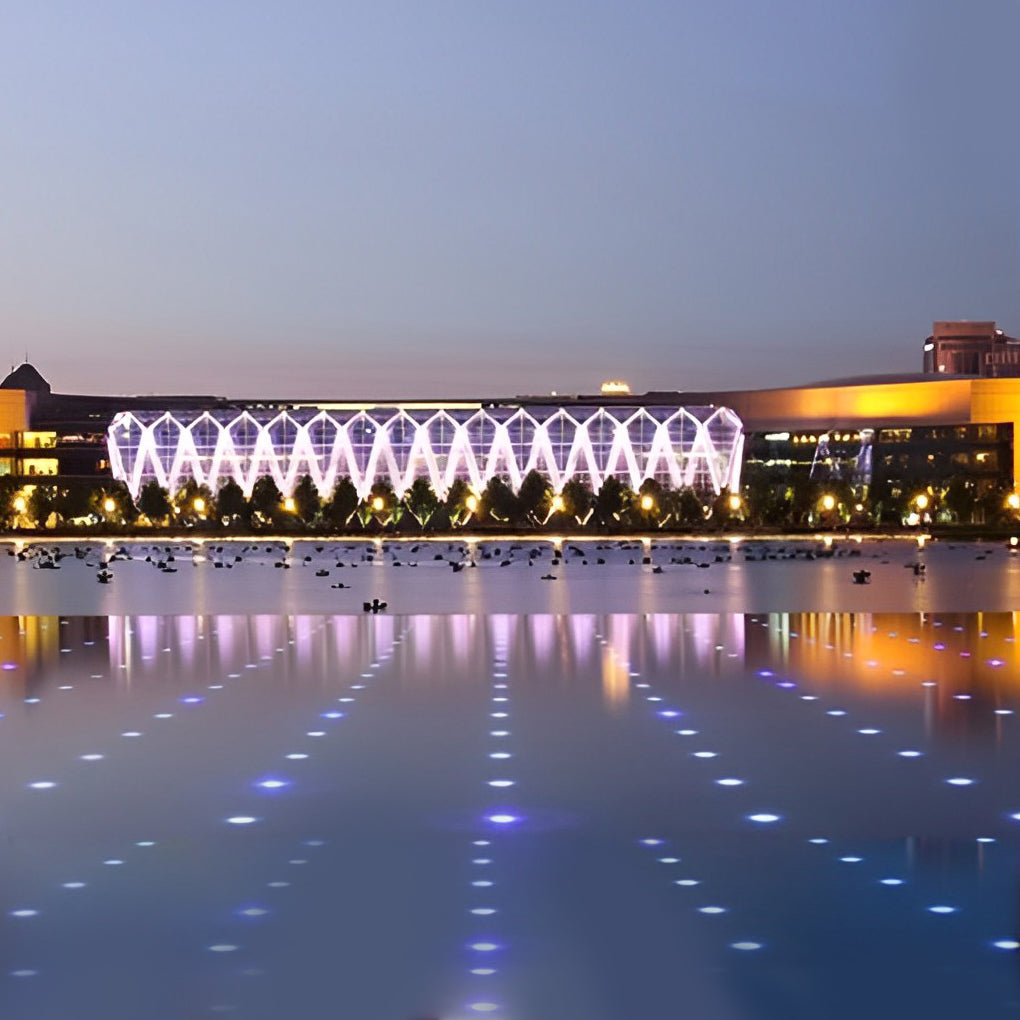 Outdoor step light fixtures casting a yellow glow on a paved pathway, enhancing nighttime visibility.
