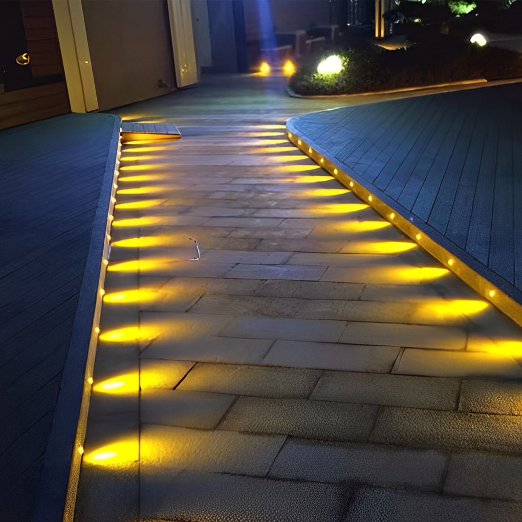 Outdoor step light fixtures lining a walkway, providing safe and elegant illumination.
